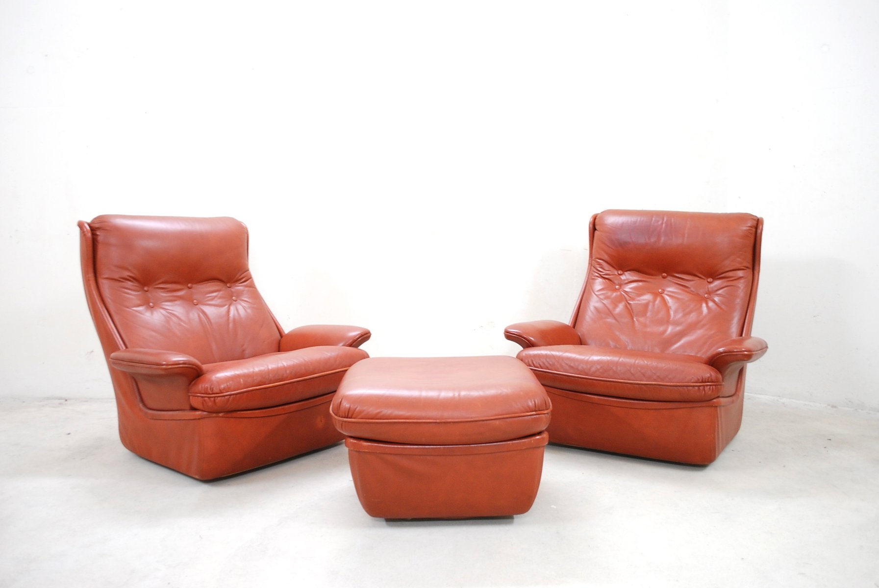 red leather lounge chairs and ottoman from airborne 2